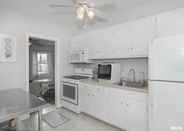 kitchen featuring white appliances, white cabinetry, and sink