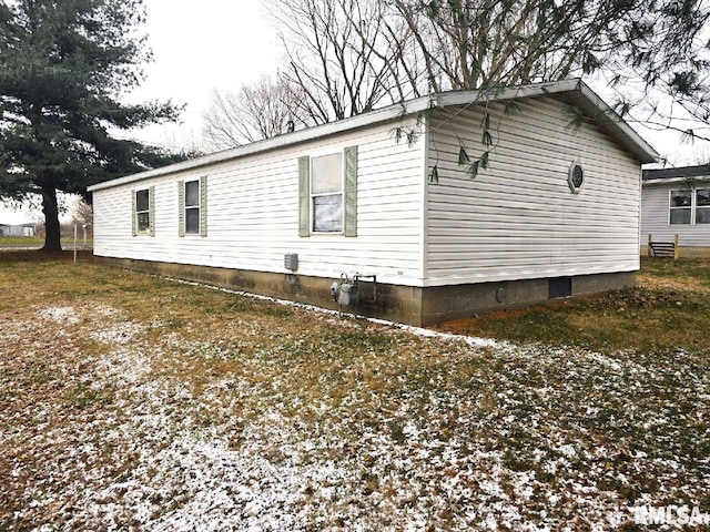 view of snowy exterior featuring a lawn