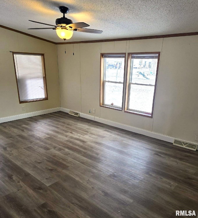 unfurnished room featuring dark hardwood / wood-style floors, ceiling fan, crown molding, and a textured ceiling