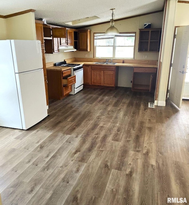 kitchen featuring a textured ceiling, white appliances, hardwood / wood-style flooring, hanging light fixtures, and lofted ceiling