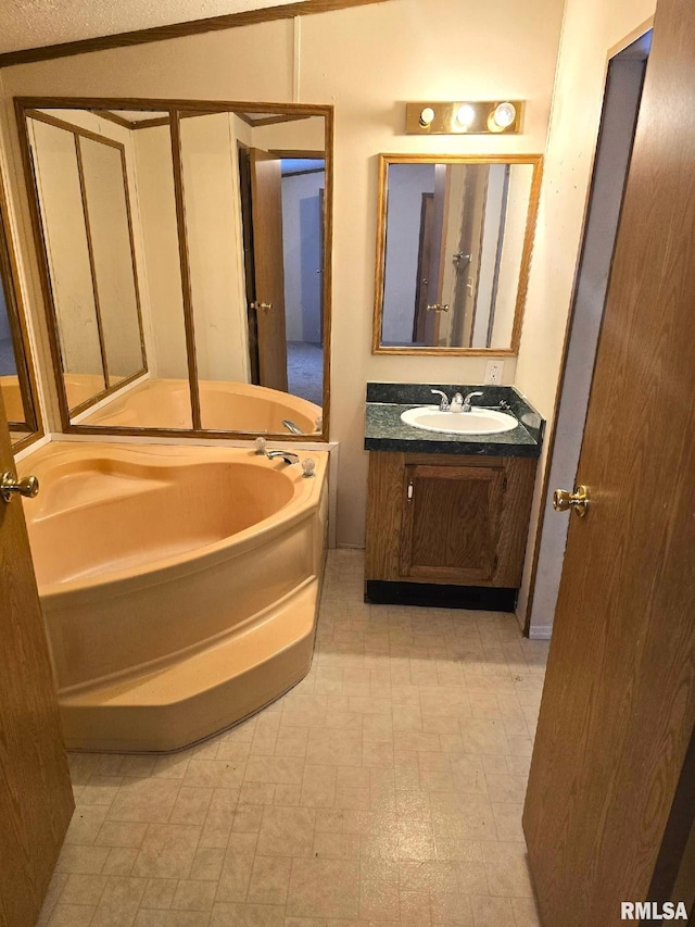 bathroom with vanity and a bath