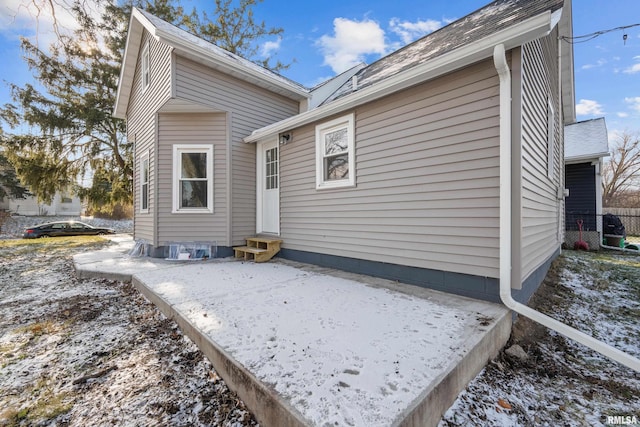 view of snow covered rear of property