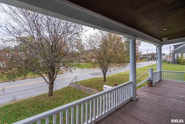 wooden terrace with a yard and a porch