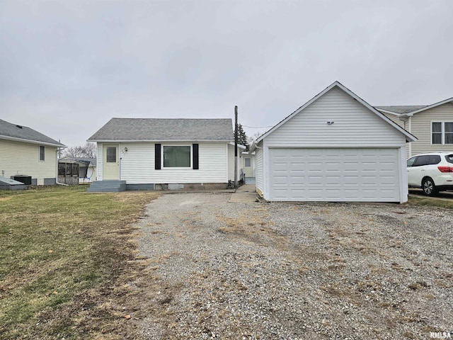 view of front facade featuring an outbuilding and a front lawn