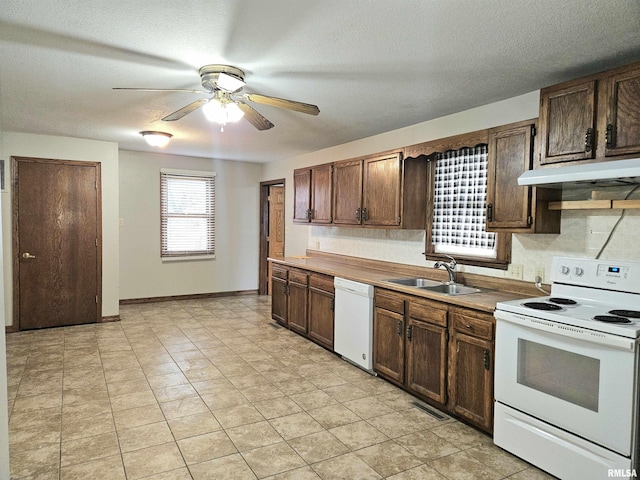 kitchen featuring a textured ceiling, ceiling fan, white appliances, and sink