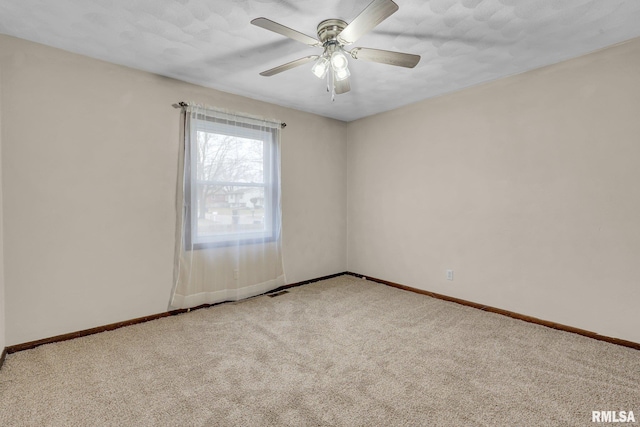 unfurnished room with ceiling fan, light colored carpet, and a textured ceiling