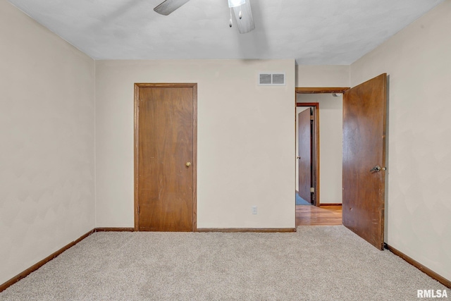 unfurnished bedroom with ceiling fan and light colored carpet