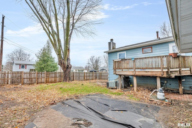 view of yard with central AC unit and a deck