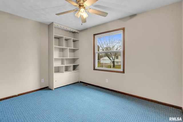 carpeted empty room featuring ceiling fan