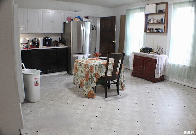 kitchen featuring white cabinetry and stainless steel fridge