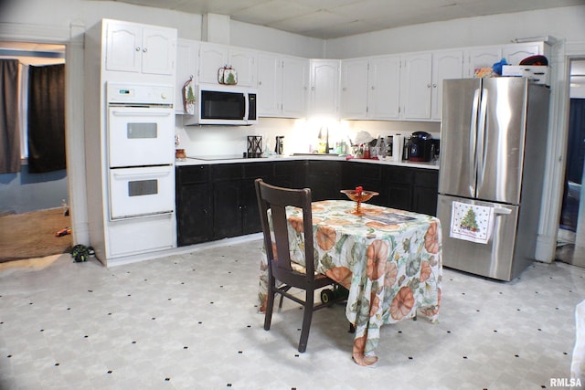 kitchen with white cabinets and white appliances