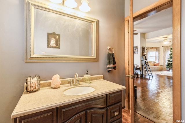 bathroom featuring ceiling fan, vanity, and wood-type flooring