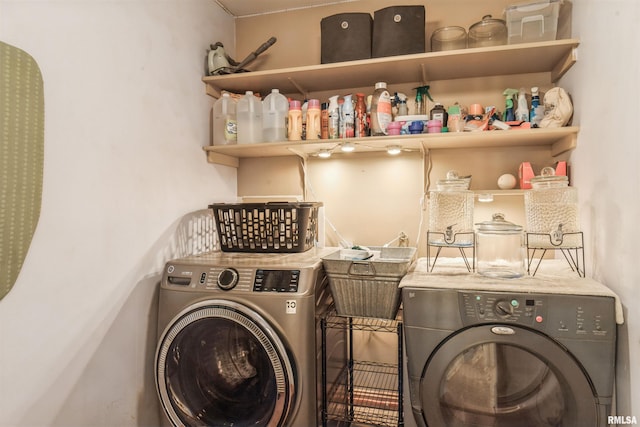 clothes washing area with washing machine and dryer