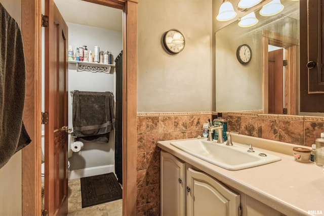 bathroom with vanity and tile walls