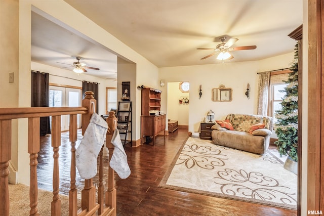 living room featuring ceiling fan, dark hardwood / wood-style flooring, and french doors