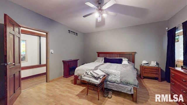 bedroom with light hardwood / wood-style flooring and ceiling fan