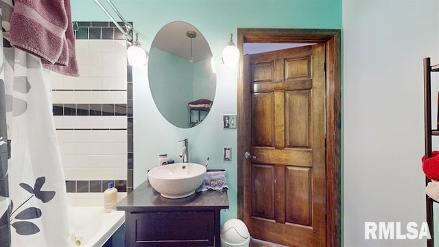 bathroom featuring vanity and shower / bathtub combination with curtain