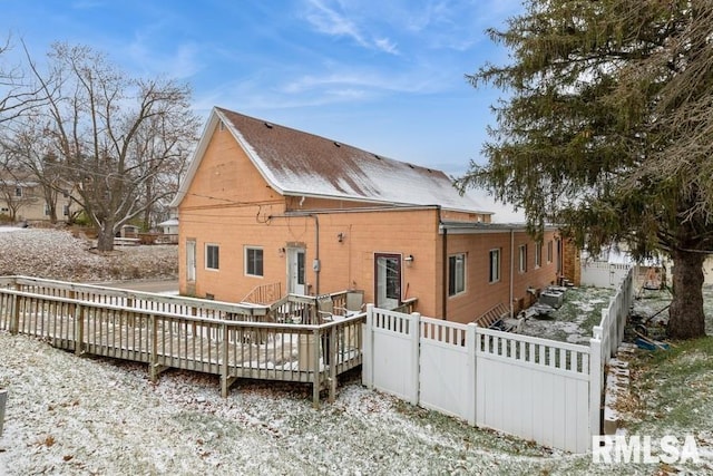 view of snow covered back of property