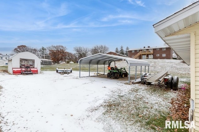 snowy yard with a carport