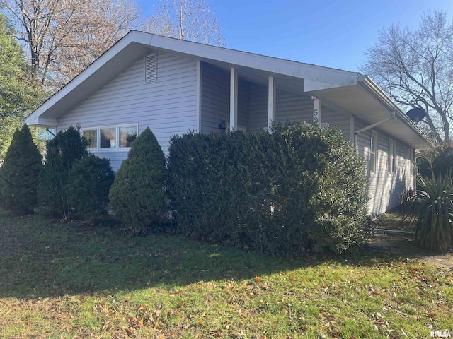 view of home's exterior with a yard