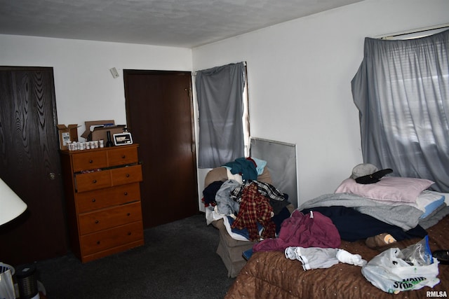 carpeted bedroom with a textured ceiling