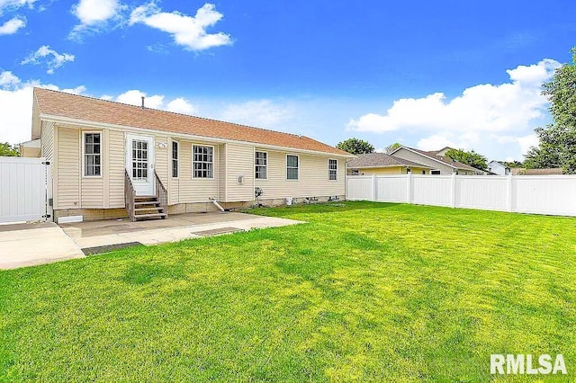 back of house featuring a lawn and a patio