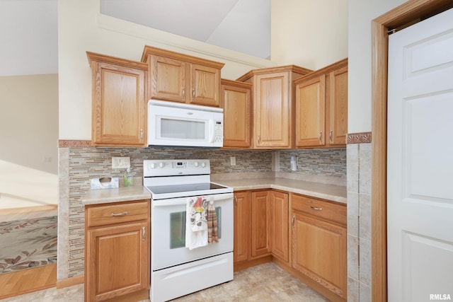 kitchen featuring decorative backsplash and white appliances