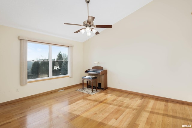 empty room featuring ceiling fan, vaulted ceiling, and hardwood / wood-style flooring