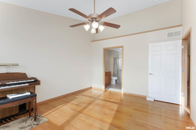 empty room featuring ceiling fan and hardwood / wood-style floors