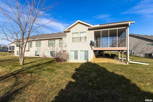 back of property featuring a lawn and a sunroom