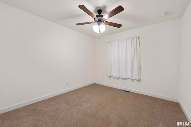 carpeted spare room with ceiling fan