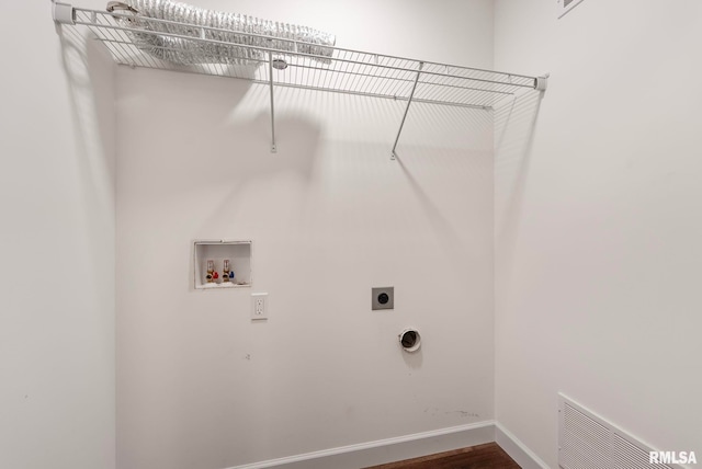 laundry area with dark hardwood / wood-style flooring, hookup for a washing machine, and hookup for an electric dryer