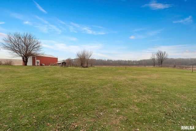 view of yard featuring an outbuilding and a rural view