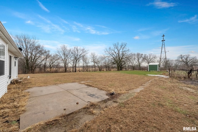 view of yard featuring a patio and a shed