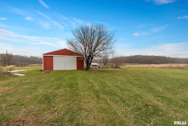 view of yard featuring a rural view and an outdoor structure