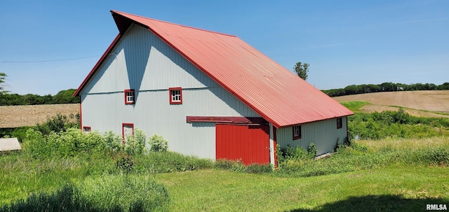 view of property exterior with an outbuilding and a lawn