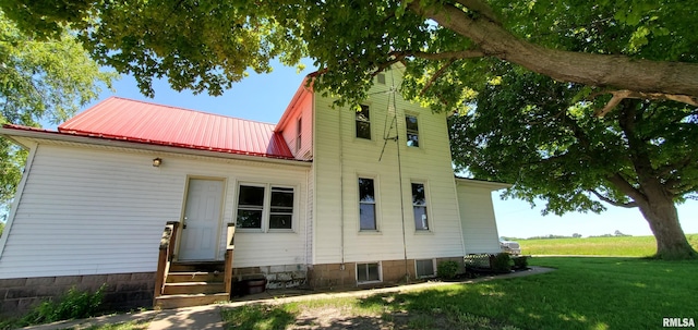 back of property featuring a lawn