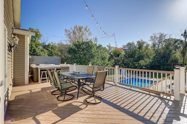 wooden deck featuring a pool with hot tub