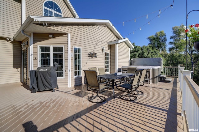 wooden terrace featuring a hot tub and a grill