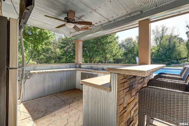 view of patio / terrace with ceiling fan and an outdoor wet bar