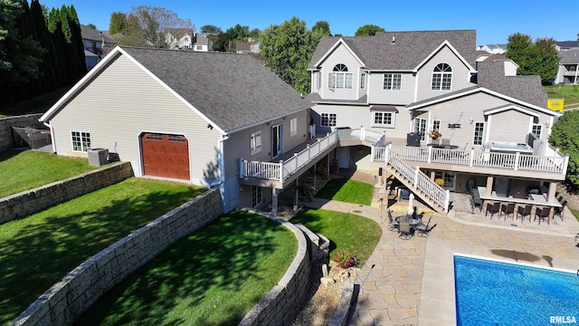 rear view of house with a bar, a swimming pool side deck, central AC unit, a patio area, and a lawn