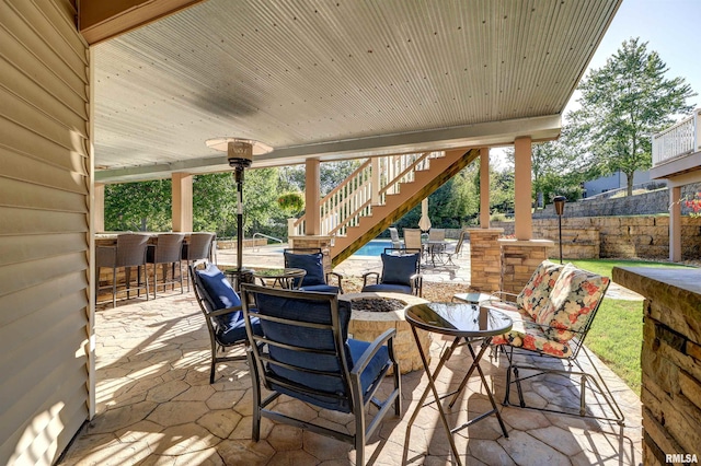 view of patio / terrace featuring a fire pit and a bar