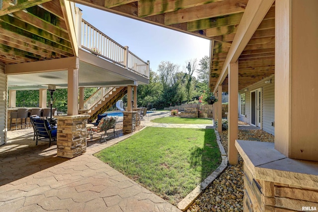 view of yard with a patio area, exterior bar, and a swimming pool