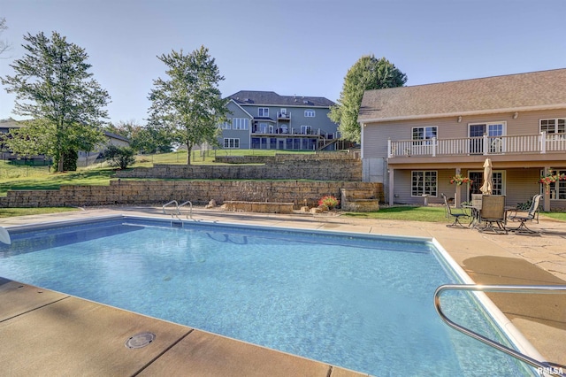 view of swimming pool with a patio area