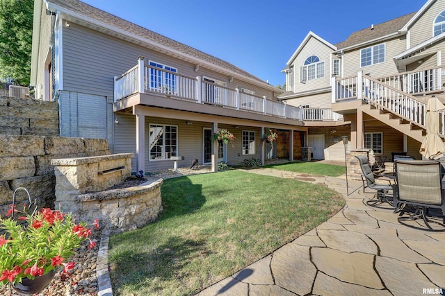 back of property with central AC, a yard, a patio, and a deck