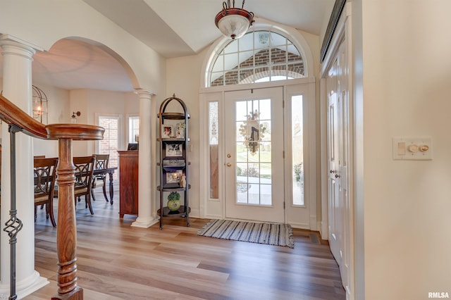 foyer entrance featuring wood-type flooring and ornate columns