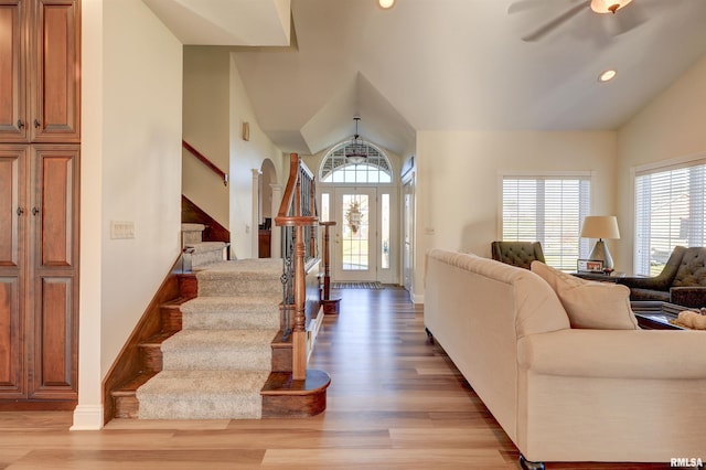 foyer entrance featuring light hardwood / wood-style floors, plenty of natural light, lofted ceiling, and ceiling fan