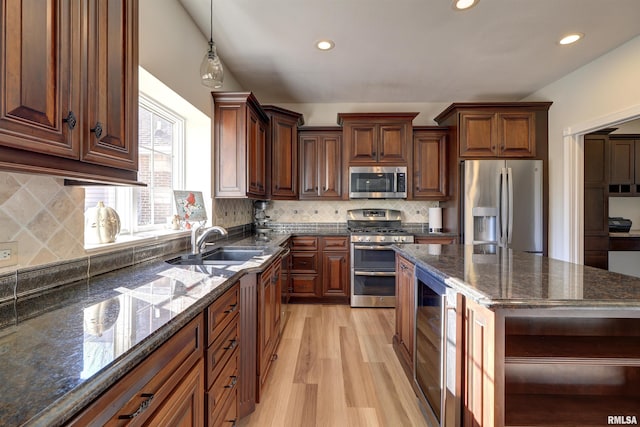 kitchen featuring sink, stainless steel appliances, wine cooler, dark stone countertops, and light hardwood / wood-style floors