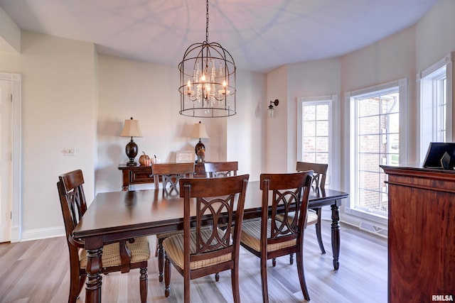 dining room featuring a chandelier and light hardwood / wood-style floors