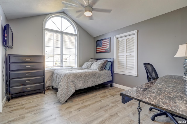 bedroom featuring a closet, light hardwood / wood-style floors, ceiling fan, and lofted ceiling